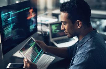 dns-services-man-looking-at-work-on-his-tablet