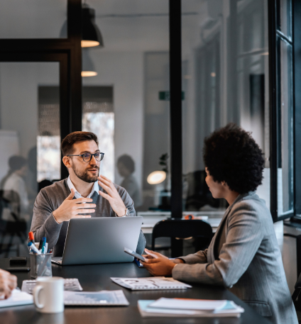 man speaking to woman in office